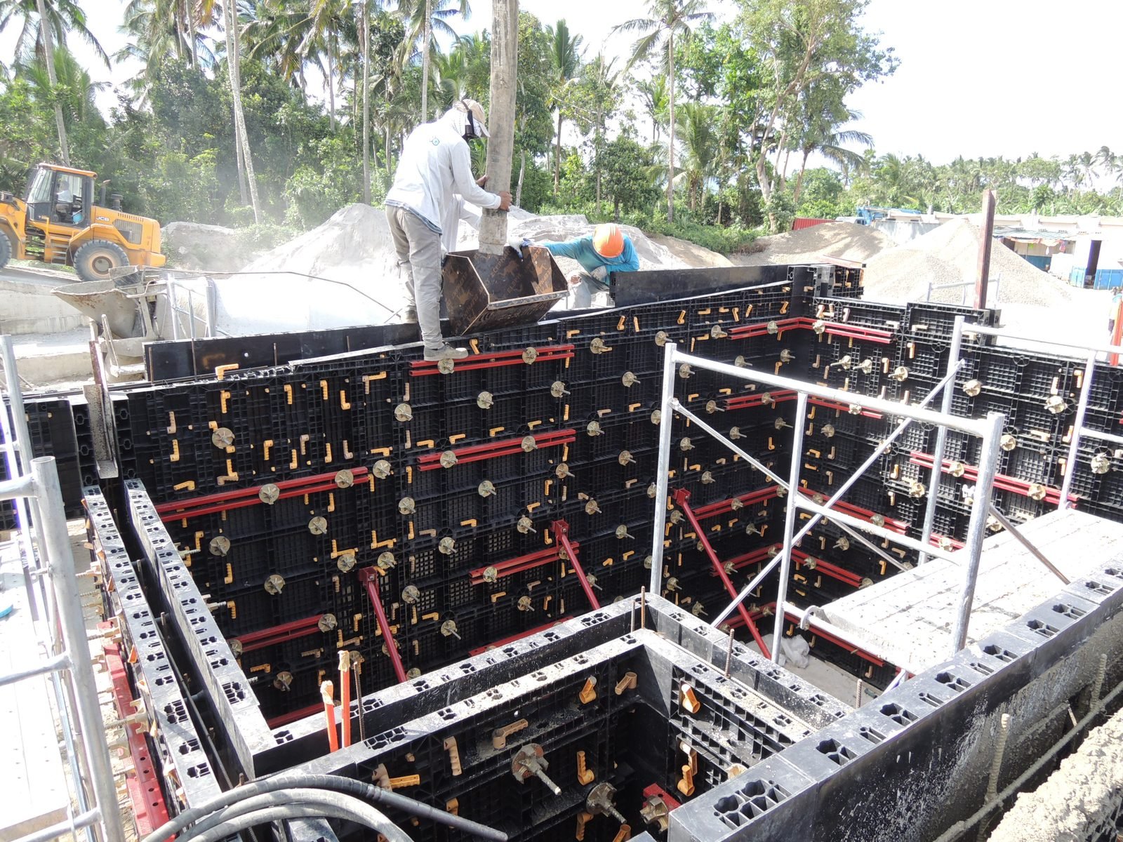 WINLONG team assembling plastic formwork panels in foundation trench